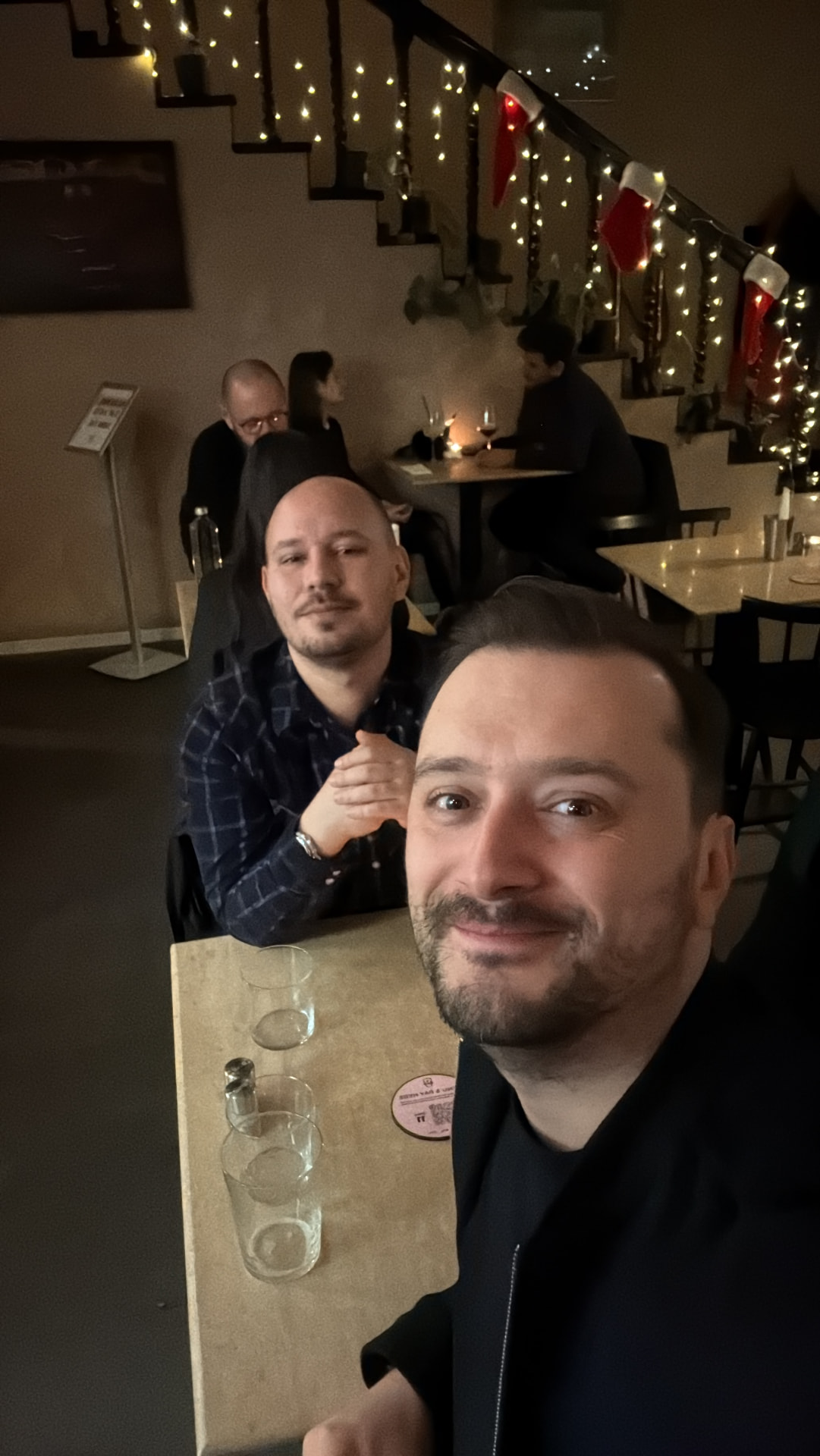 Adi and Bala at a festive restaurant table